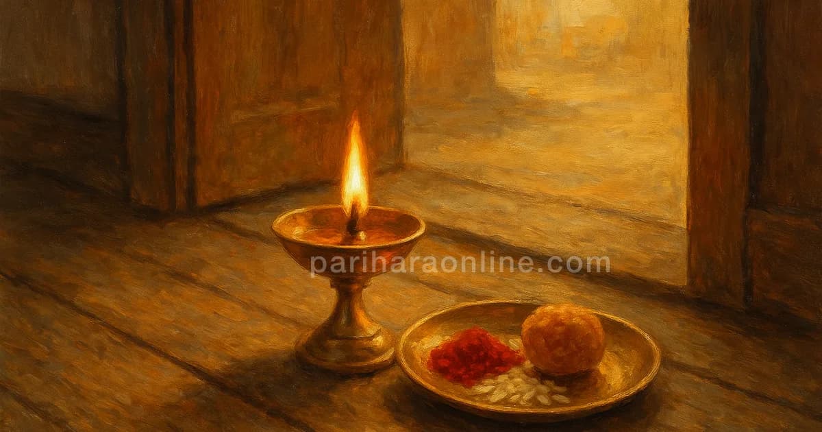 Brass tilak plate with a lit lamp, kumkum, rice grains and a sweet beside a doorway — bhai dooj meaning | pariharaonline.com