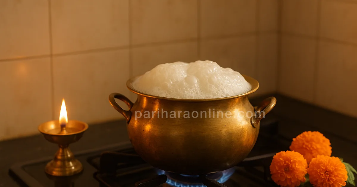 Milk boiling over in a brass pot on a new stove beside a lit oil lamp and marigolds — griha pravesh puja | pariharaonline.com