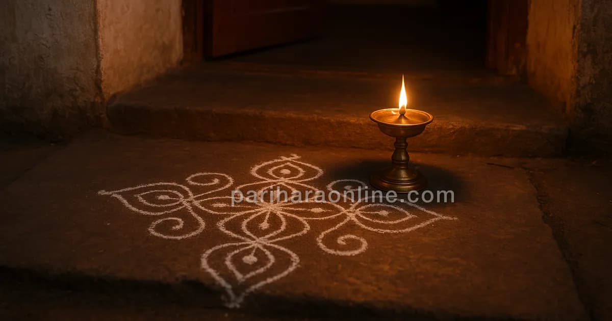Single brass lamp glowing on a stone threshold at dusk surrounded by a rice-flour kolam — why do hindus light lamps | pariharaonline.com