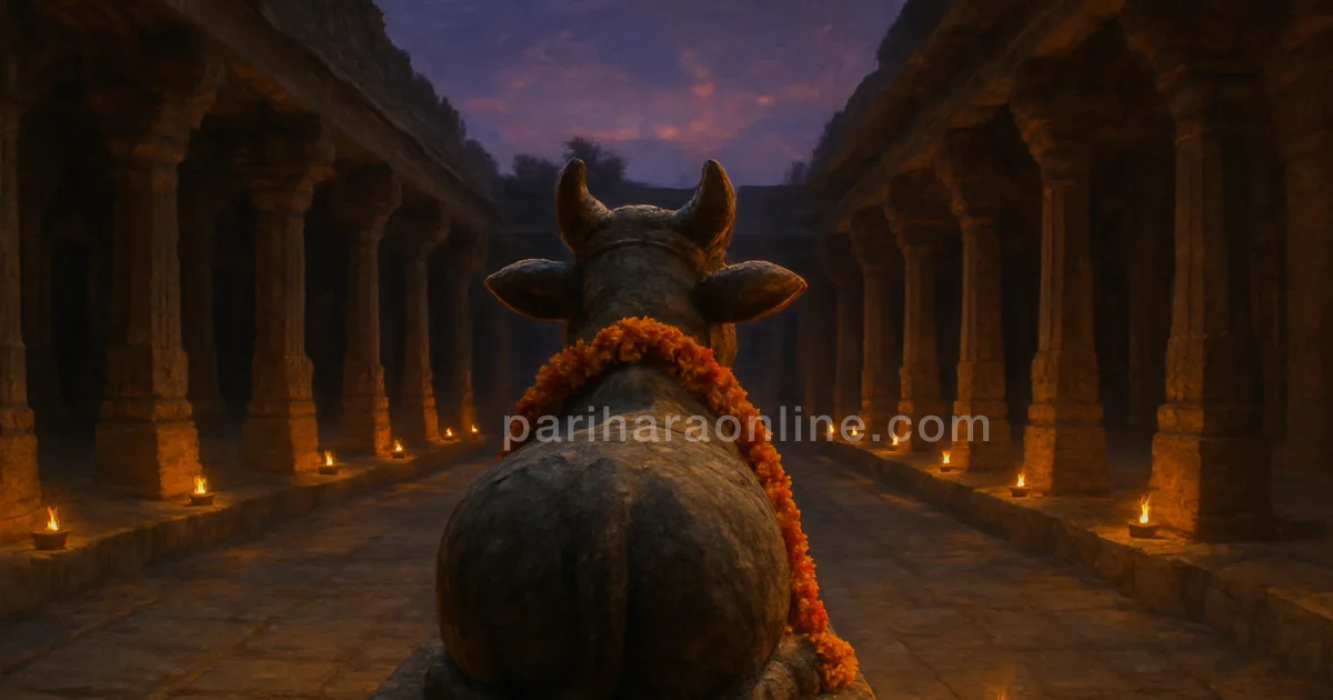 Stone Nandi with marigold garland in a temple courtyard at twilight, oil lamps along the corridor — pradosham meaning | pariharaonline.com