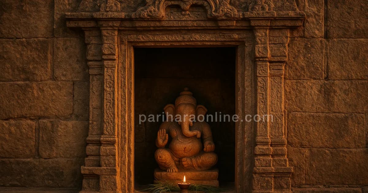 Carved temple doorway at golden hour with a small niche, durva grass and a lit oil lamp — why ganesha is worshipped first | pariharaonline.com